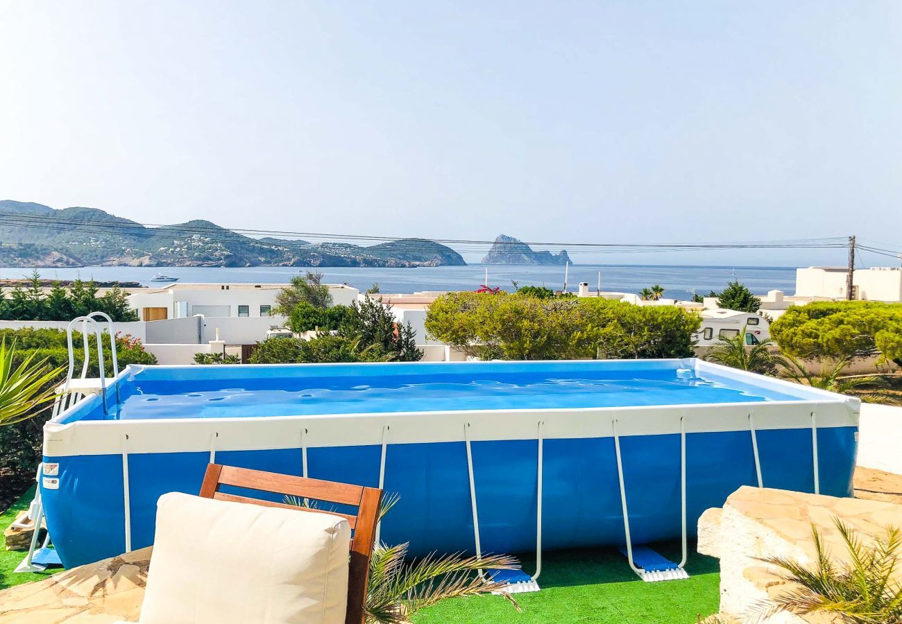 Swimming pool of the villa Pins in Ibiza with the sea in the background